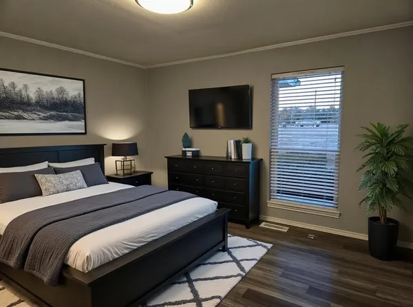 a bedroom with a bed and a flat screen tv
