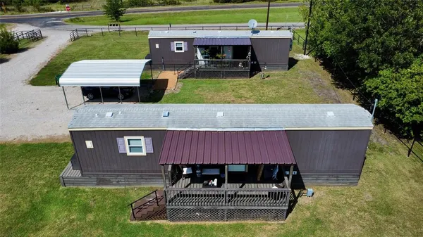a aerial view of a house with a garden and trees