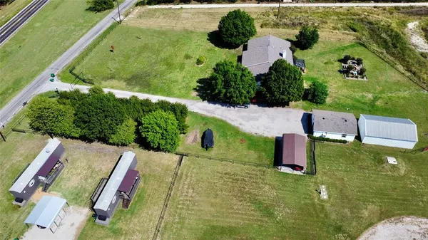 an aerial view of house with yard