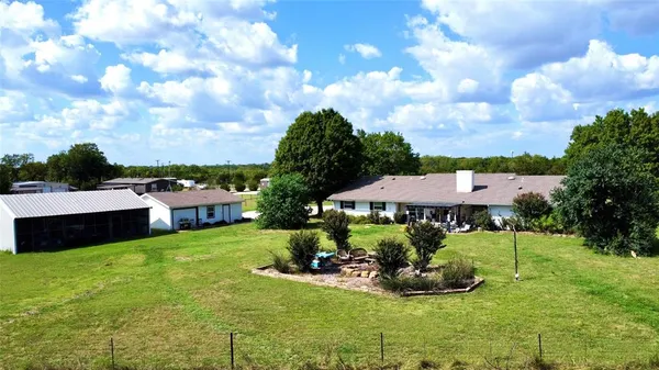 a view of a garden with a house in the background