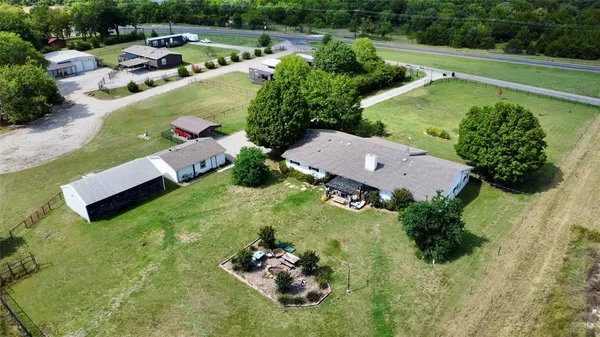 an aerial view of a house with a garden swimming pool and outdoor seating