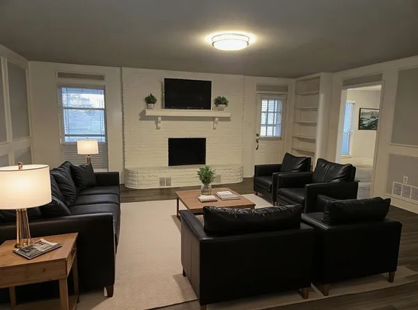a living room with furniture a fireplace and a flat screen tv