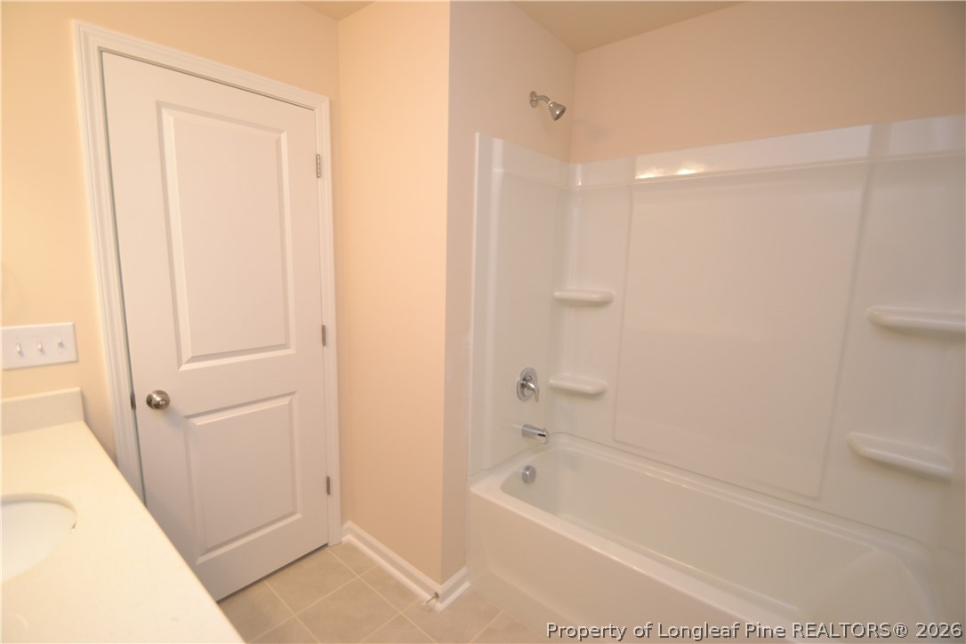 5703 Preveza Place Raleigh, NC 27603 - Photo 16 of 33 a bathroom with a bathtub and a shower