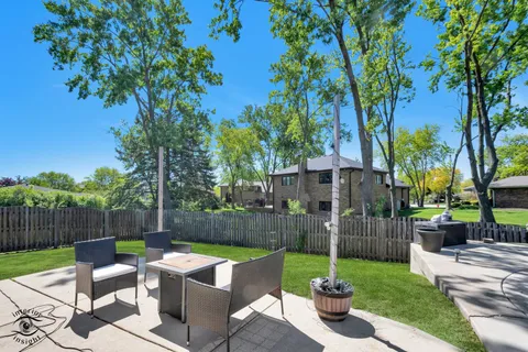 a view of a backyard with sitting area