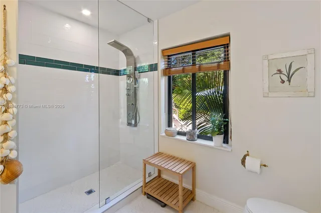 a bathroom with a shower and a window