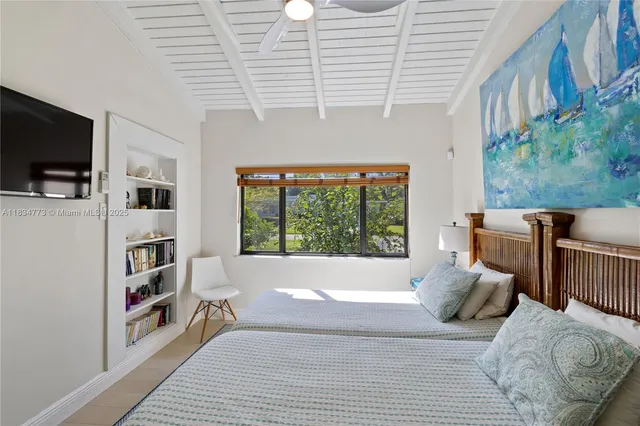 a bedroom with furniture and a flat screen tv