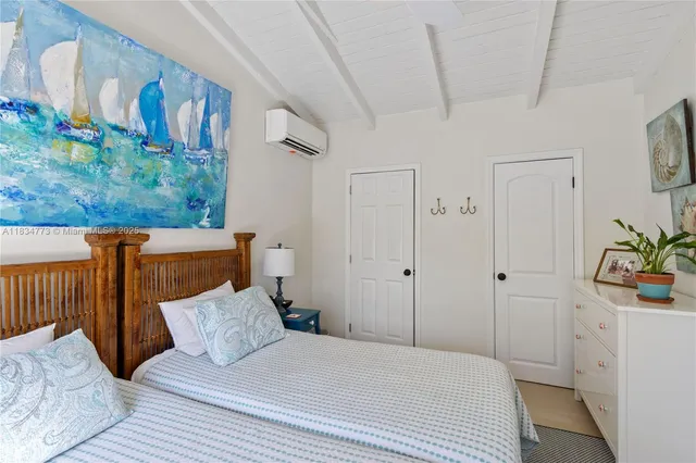 a bedroom with a bed and a potted plant