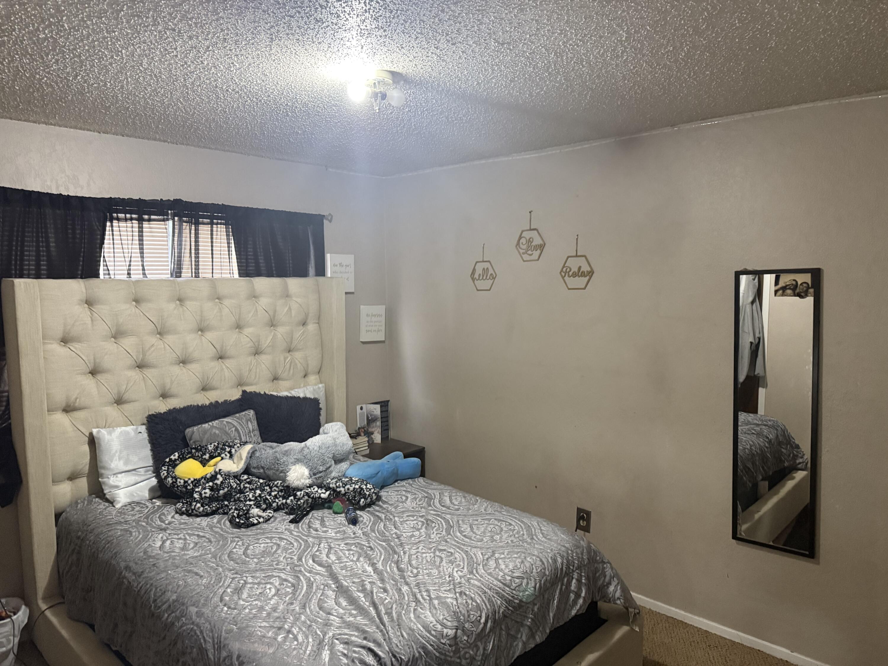 6315 29th Street Lubbock, TX 79407 - Photo 12 of 12 a bed sitting in a room next to a lamp