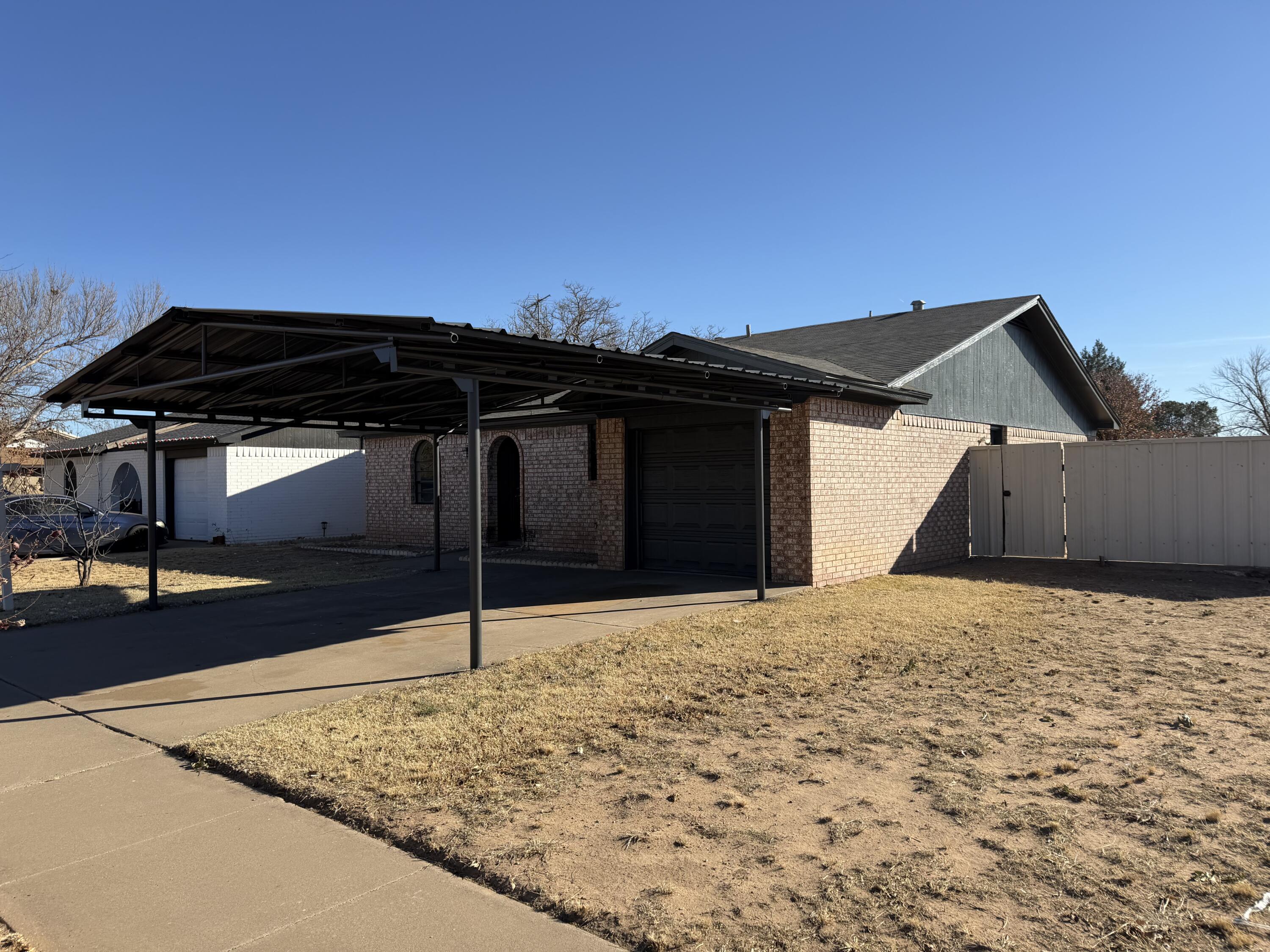6315 29th Street Lubbock, TX 79407 - Photo 2 of 12 a backyard of a house with table and chairs