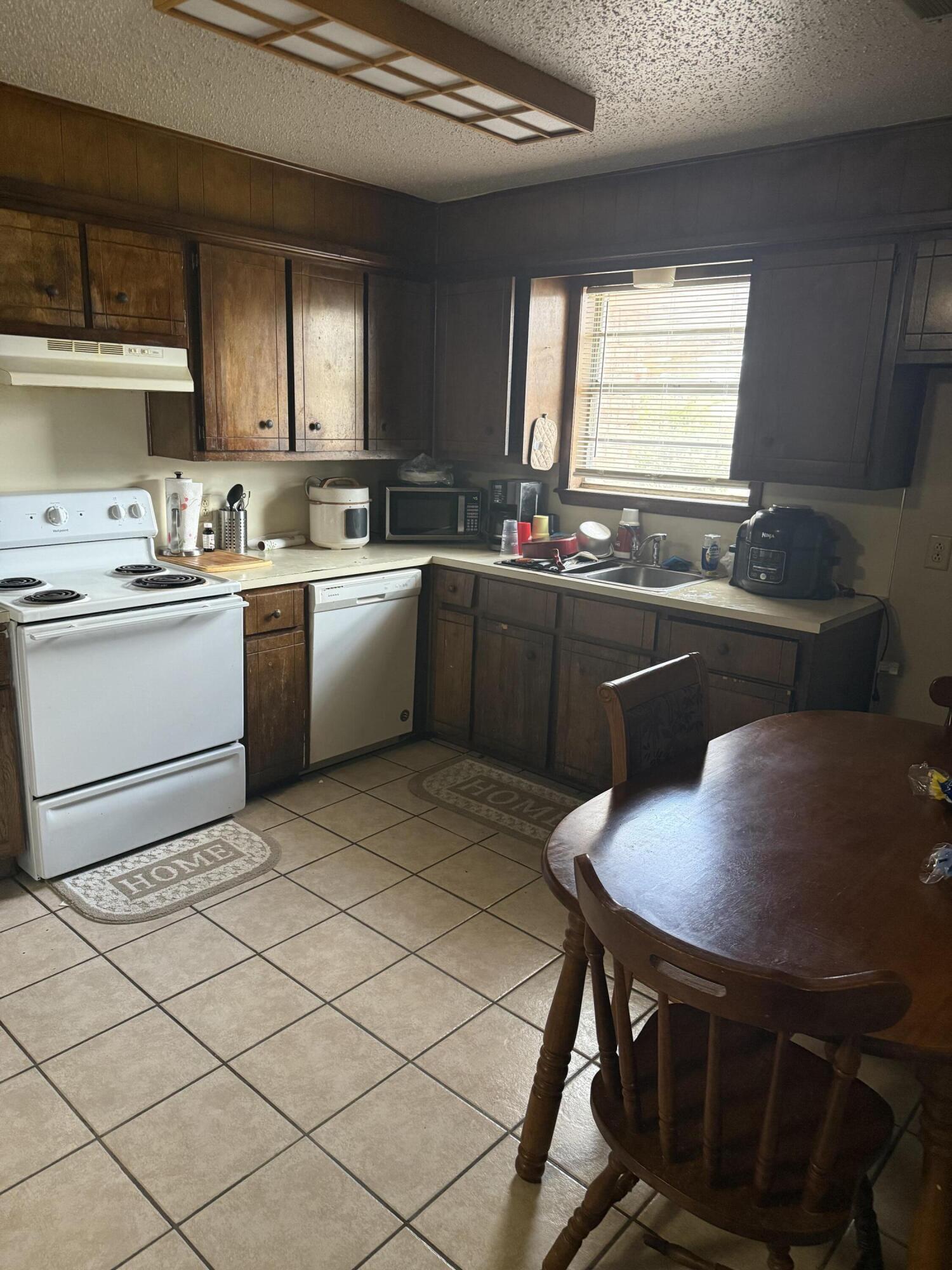 6315 29th Street Lubbock, TX 79407 - Photo 9 of 12 a kitchen with a table chairs sink and cabinets