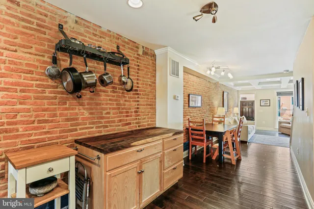 a kitchen with stainless steel appliances granite countertop a stove and a dining table