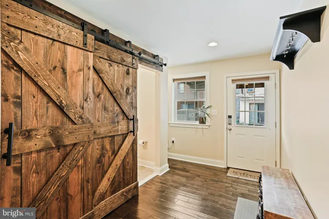 a view of entryway with wooden floor and stairs