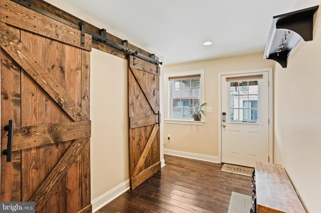 a view of an entryway with wooden floor and door