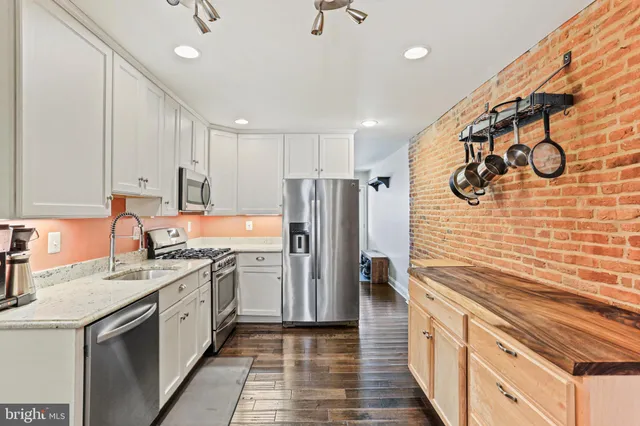 a kitchen with a sink appliances and cabinets