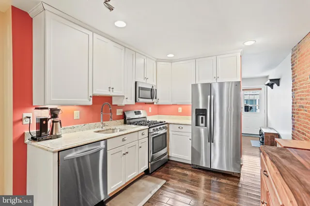 a kitchen with a sink stove and refrigerator