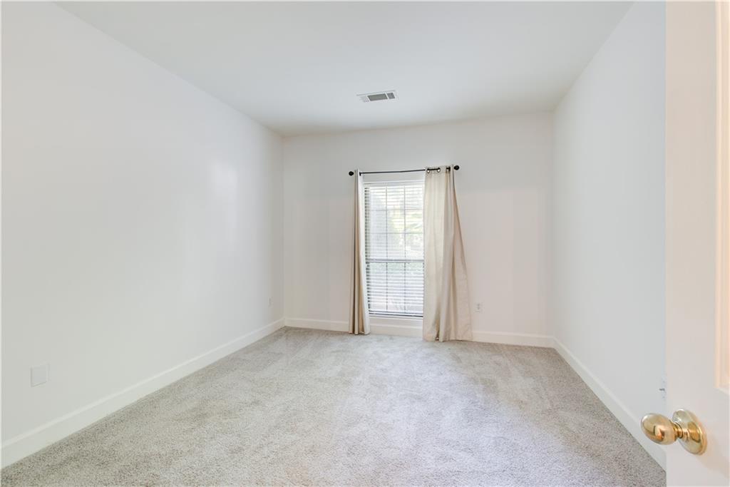 2865 Lenox Road Northeast, Unit 102 Atlanta, GA 30324 - Photo 12 of 35 an empty room with windows