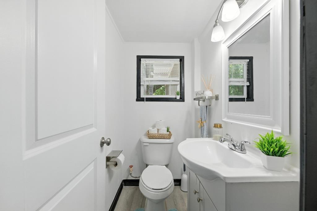 1637 Starratt Road Jacksonville, FL 32218 - Photo 20 of 44 a bathroom with a sink mirror vanity and a toilet