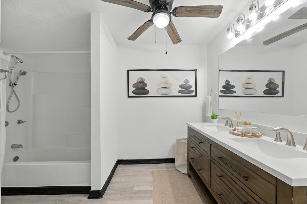 1637 Starratt Road Jacksonville, FL 32218 - Photo 29 of 44 a bathroom with a granite countertop sink a mirror a vanity and shower