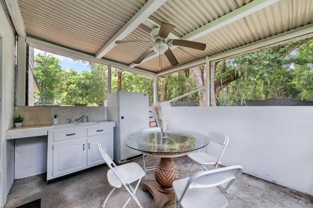 1637 Starratt Road Jacksonville, FL 32218 - Photo 40 of 44 a dining room with furniture windows and a chandelier