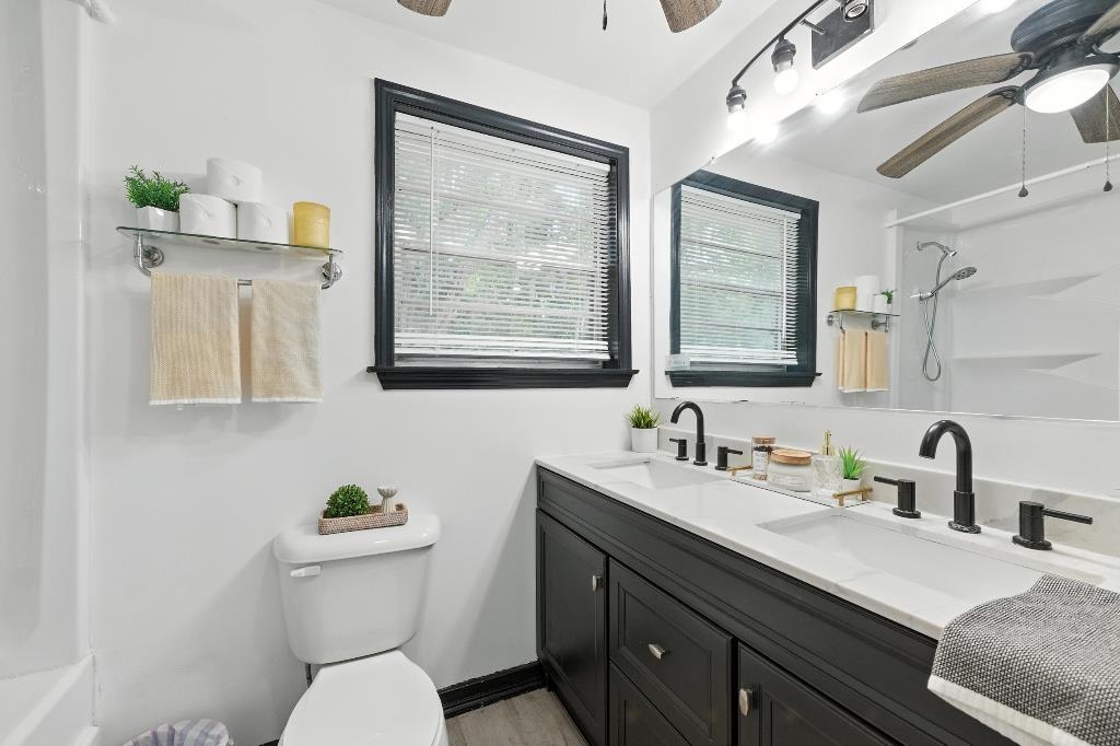 1637 Starratt Road Jacksonville, FL 32218 - Photo 7 of 44 a bathroom with a granite countertop toilet sink and mirror