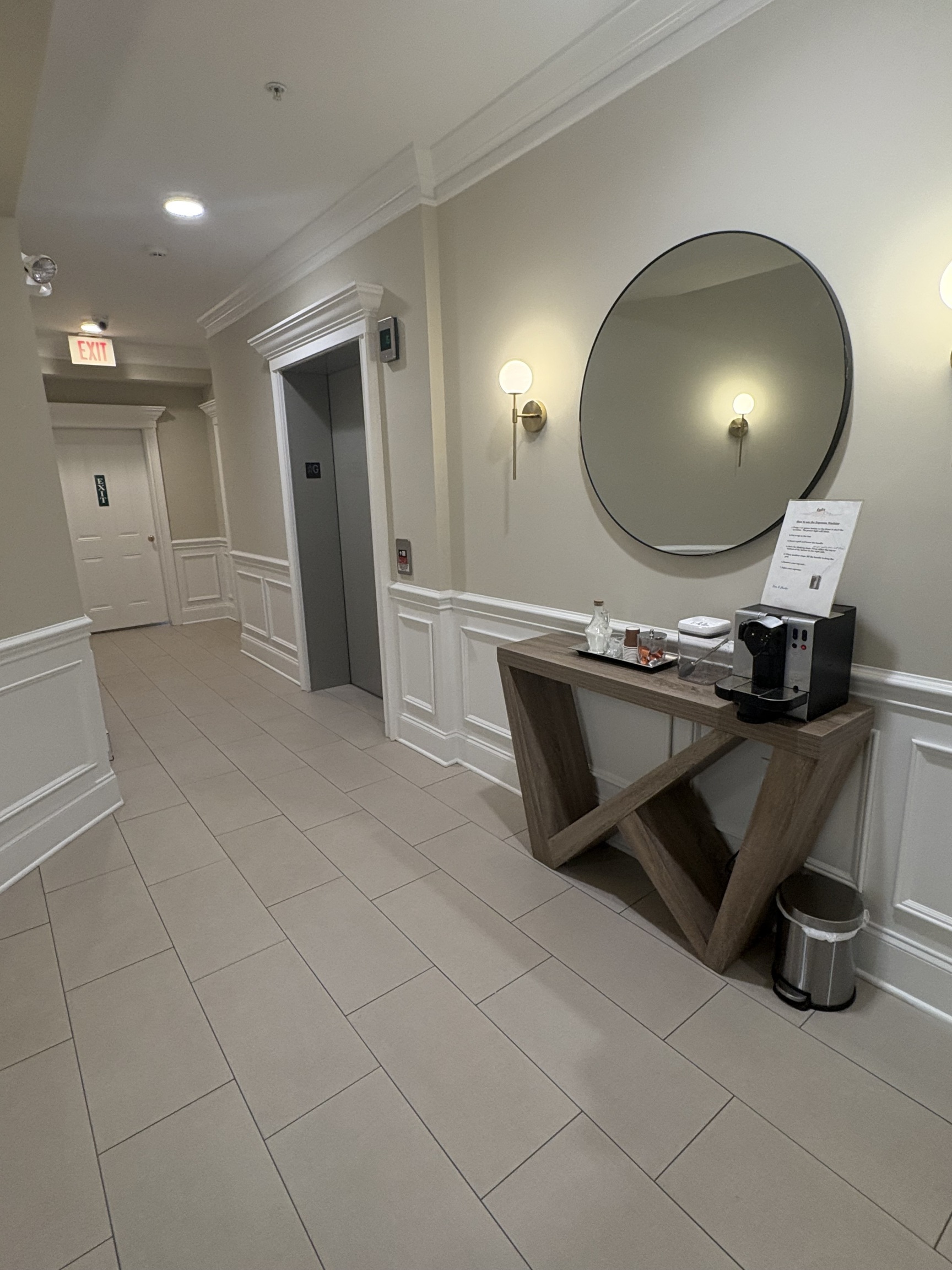 a kitchen with a sink and a mirror