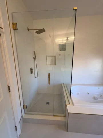 a bathroom with a bathtub and a shower