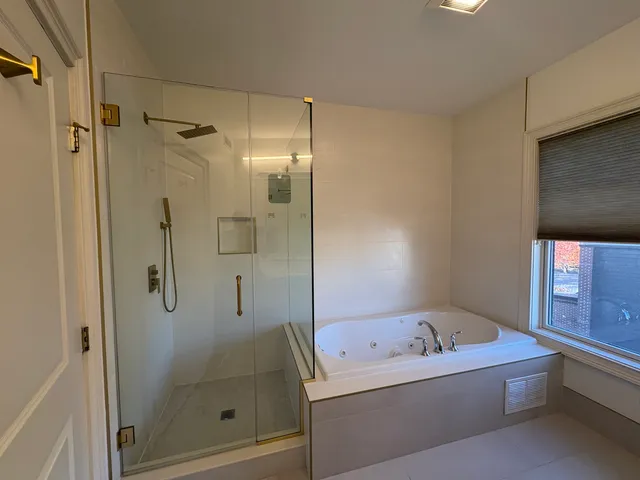 a bathroom with a bathtub and a shower