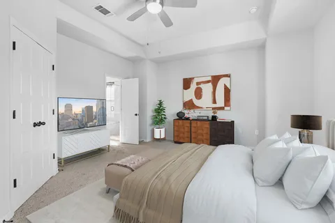 a spacious bedroom with a bed and a couch