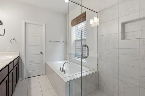 a bathroom with a bathtub and shower