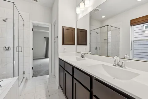 a bathroom with double sink and a mirror