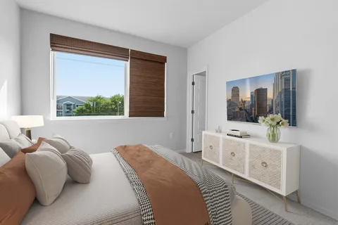 a bedroom with a large bed and a window