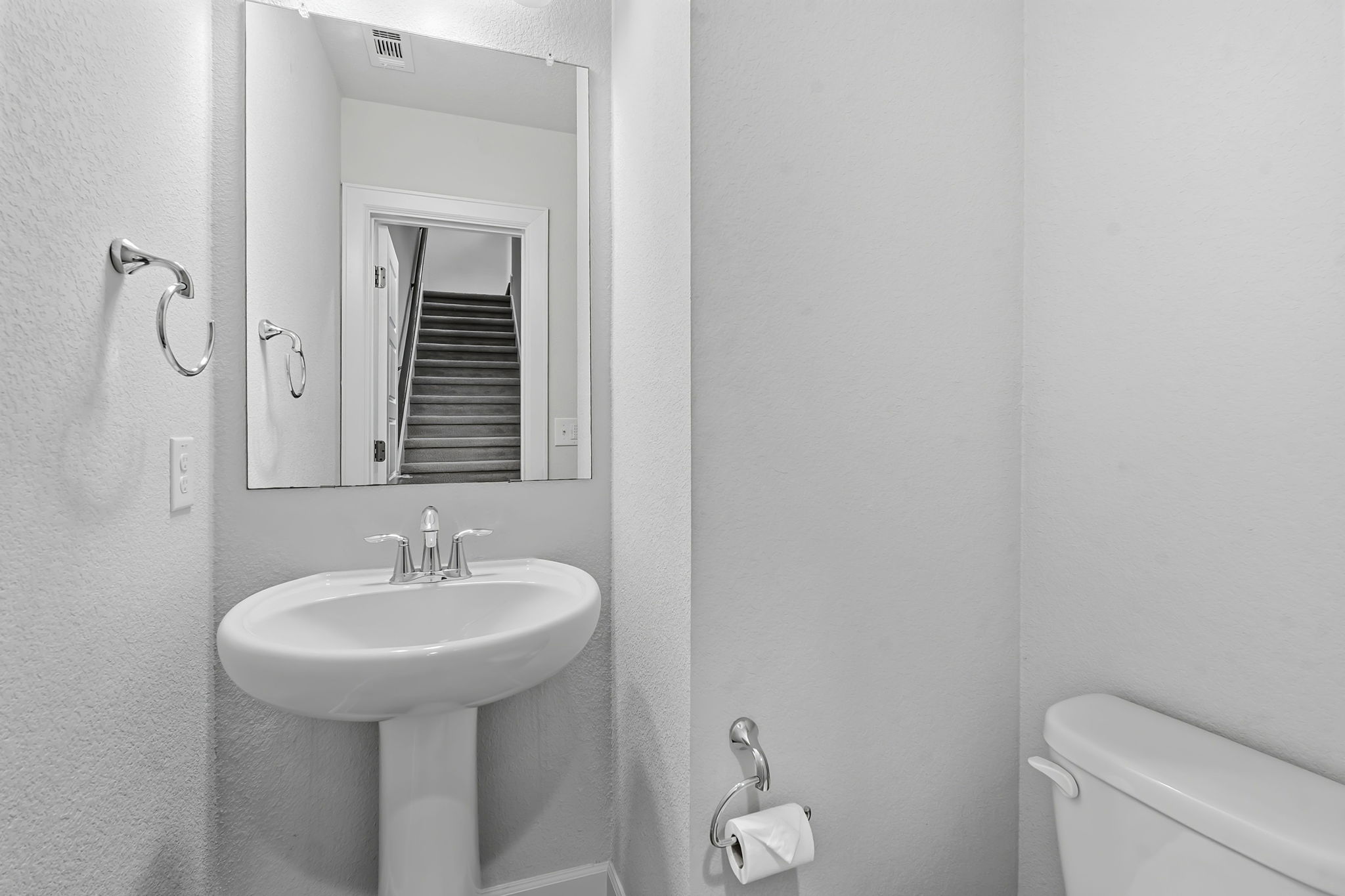 4409 Festival Path, Unit 26 Austin, TX 78741 - Photo 17 of 21 a bathroom with a sink a toilet and mirror