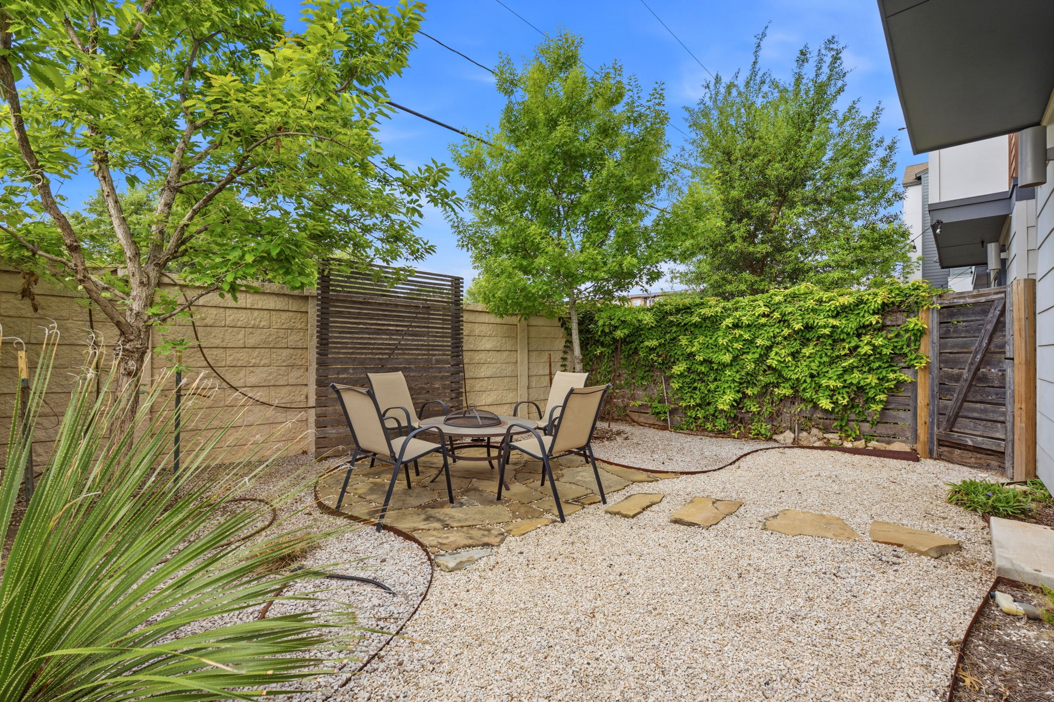 4409 Festival Path, Unit 26 Austin, TX 78741 - Photo 18 of 21 a view of backyard with a table and chairs and potted plants