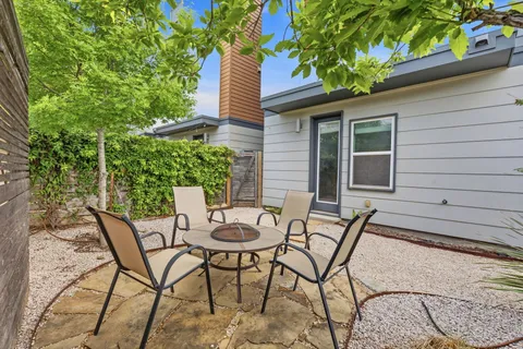 a view of an chairs and table in the patio