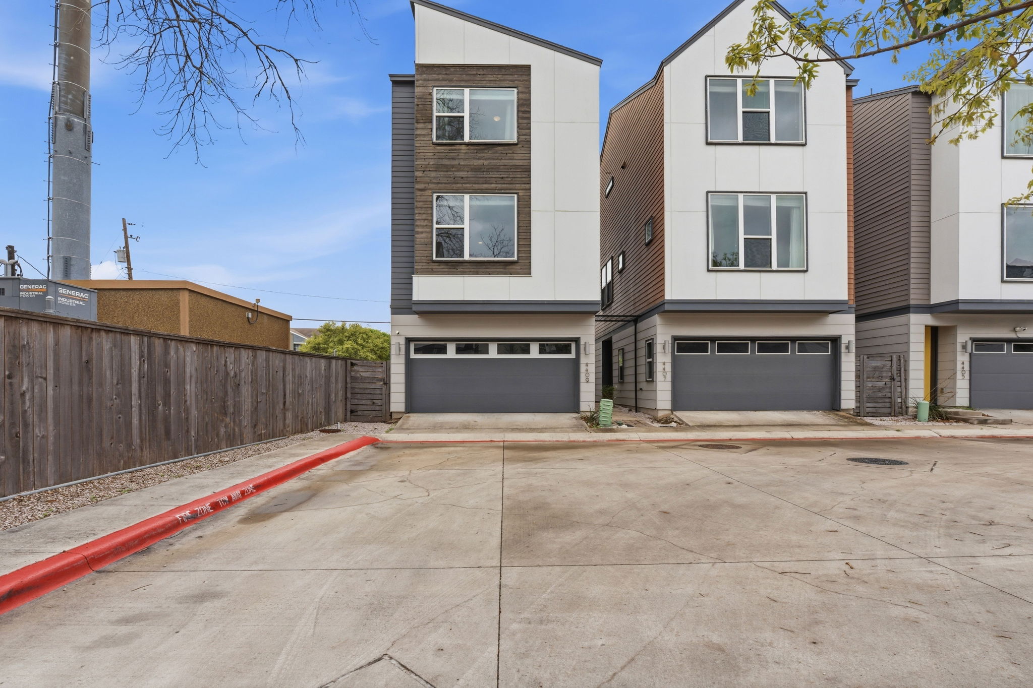 4409 Festival Path, Unit 26 Austin, TX 78741 - Photo 2 of 24 Contemporary house with an attached garage and concrete driveway