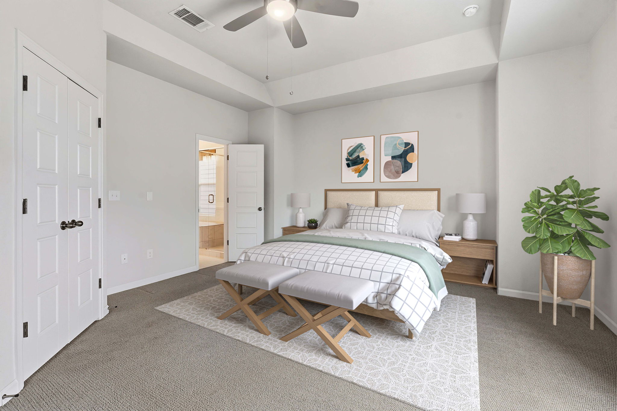 4409 Festival Path, Unit 26 Austin, TX 78741 - Photo 7 of 24 Bedroom featuring light colored carpet, ensuite bathroom, ceiling fan, and a raised ceiling