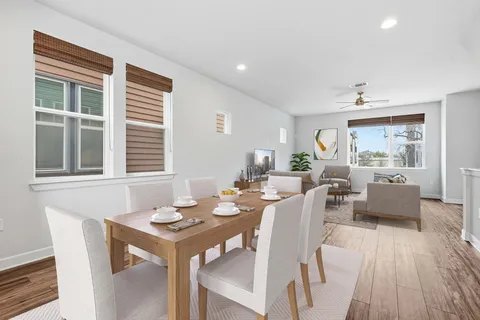 a view of a dining room with furniture and wooden floor