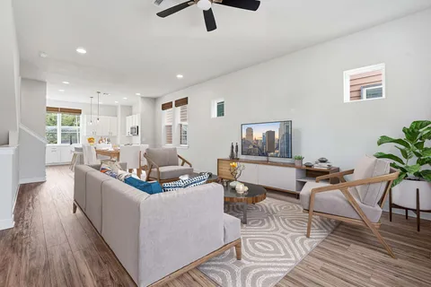 a living room with furniture and a wooden floor