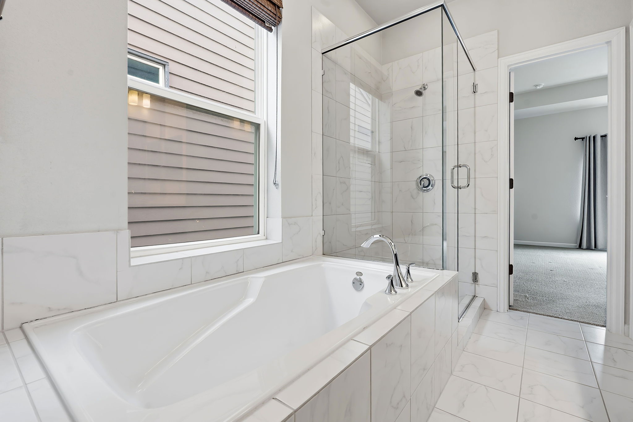 4409 Festival Path, Unit 26 Austin, TX 78741 - Photo 10 of 24 Full bathroom featuring a shower stall, a bath, and light marble finish floors