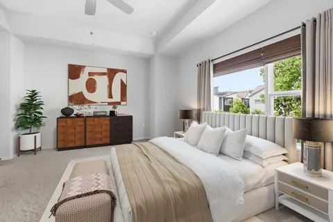 a bedroom with a bed and dresser with mirror