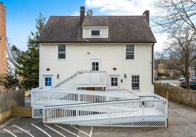 a view of a white house with a yard