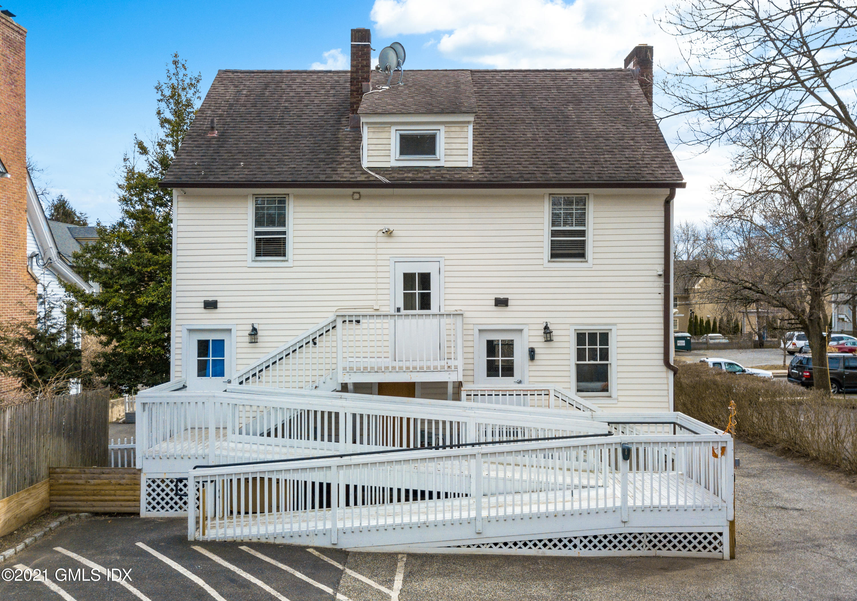 75 Mason Street Greenwich, CT 06830 - Photo 8 of 11 a view of a white house with a yard