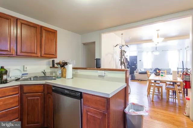 a kitchen with a sink cabinets and wooden floor