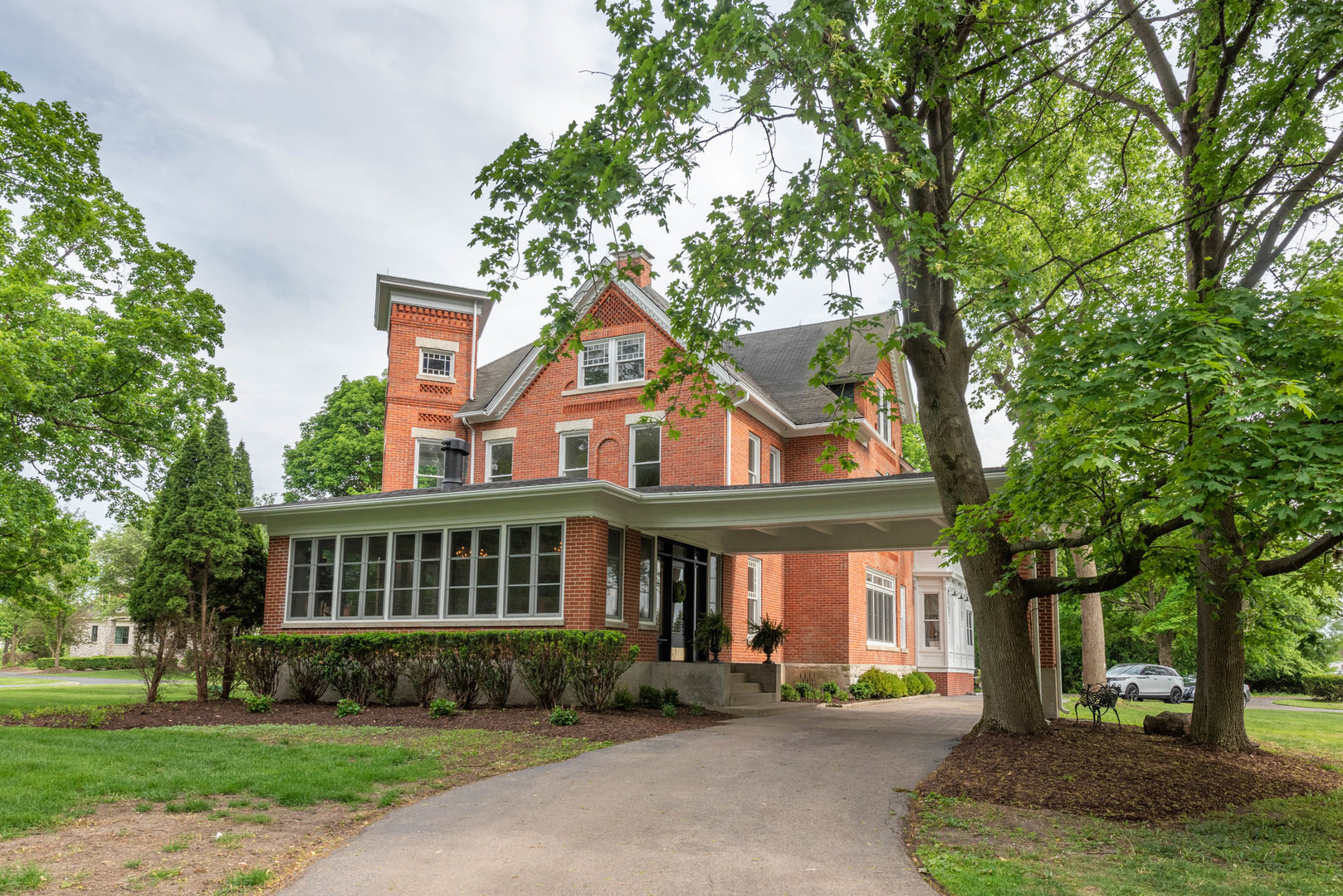 a front view of a house with a garden