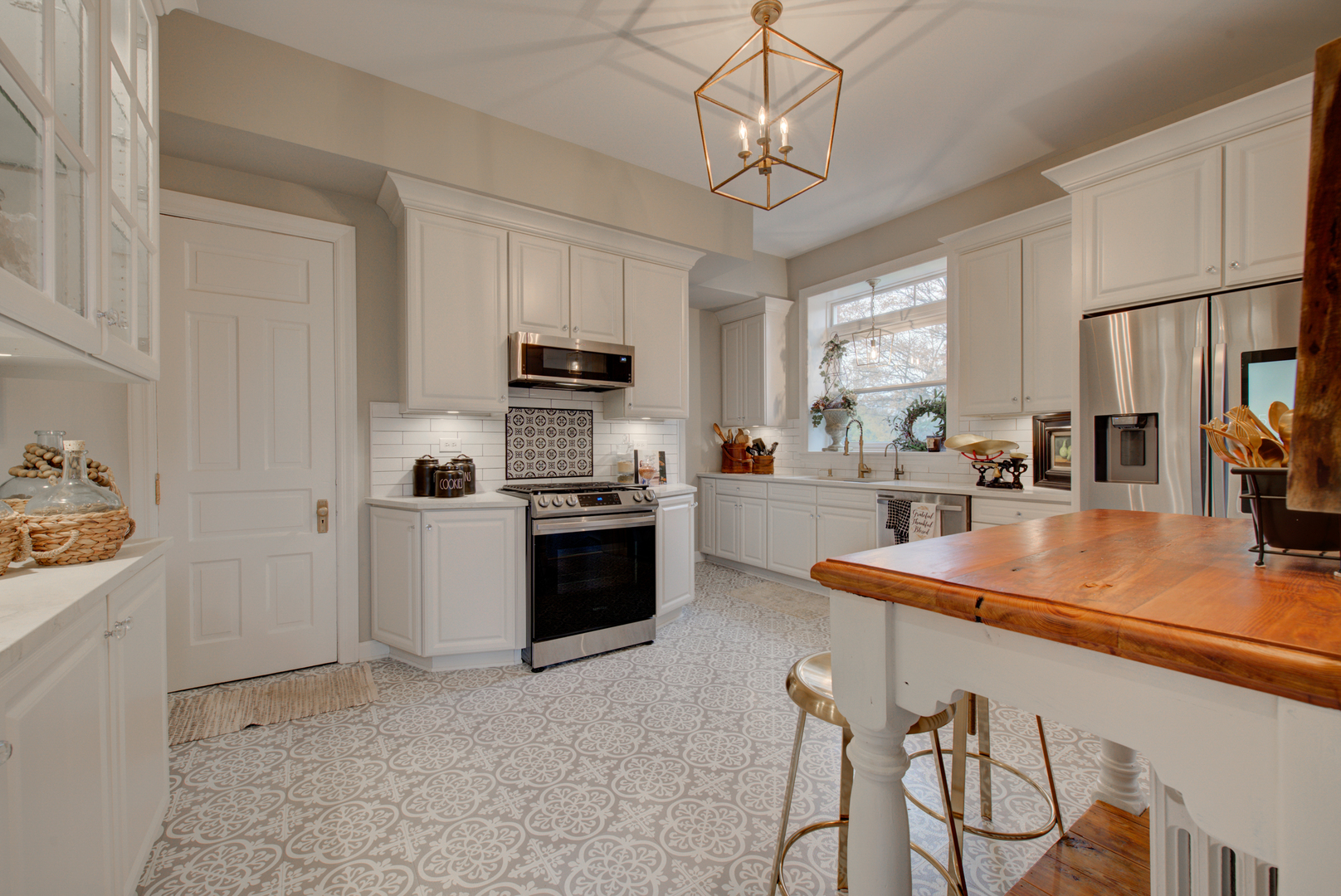 31W141 Army Trail Road Wayne, IL 60184 - Photo 19 of 63 a kitchen with kitchen island granite countertop stainless steel appliances cabinets a sink and a counter space