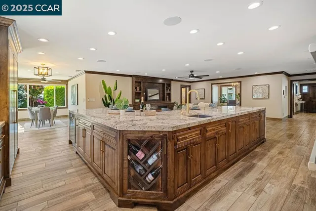 a kitchen with stainless steel appliances granite countertop a refrigerator and a stove top oven