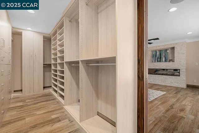 a bathroom with a granite countertop sink a mirror and shower