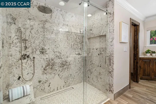 a bedroom with a large bed and a chandelier