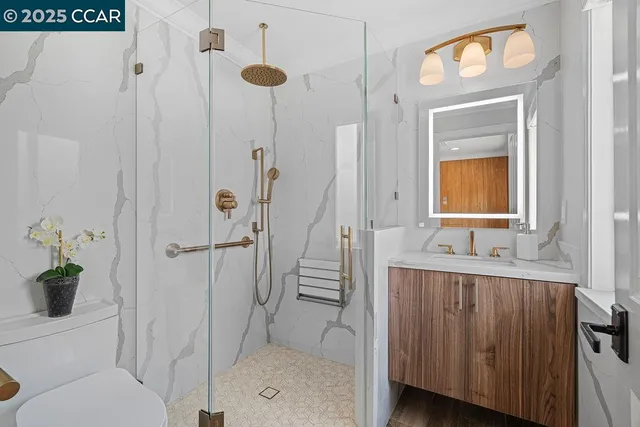 a bathroom with a granite countertop shower