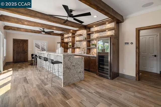 a kitchen with stainless steel appliances kitchen island granite countertop a stove top oven microwave and refrigerator